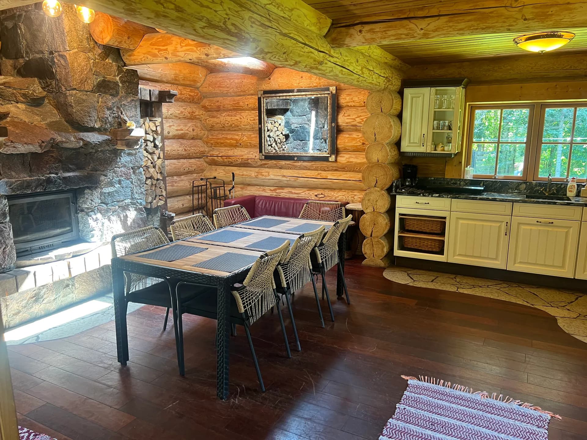 Open living area with a stone fireplace