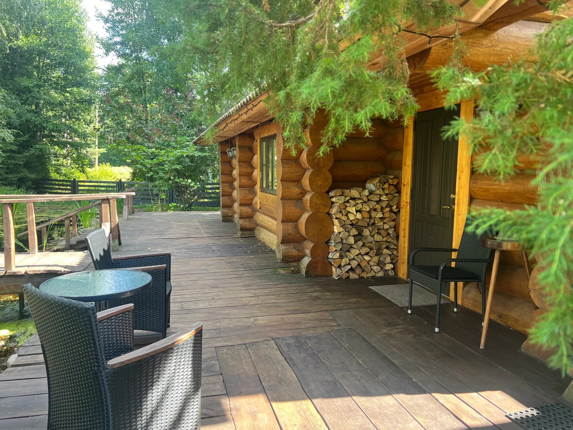 Wooden terrace with table and chairs in the sun