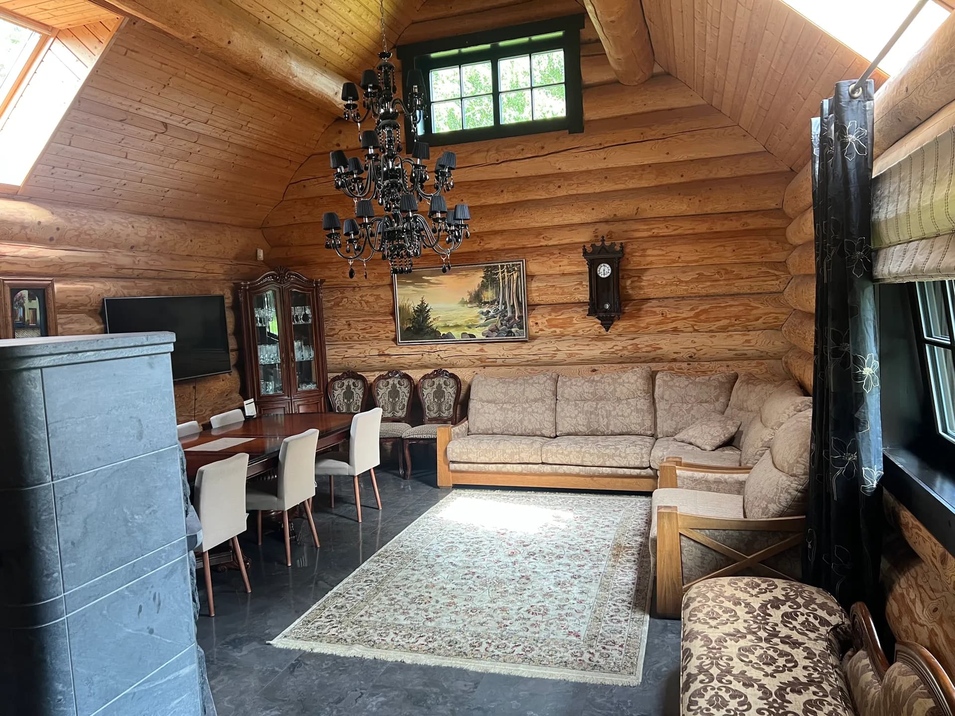 Spacious living room with a fireplace, sofa, and dining table