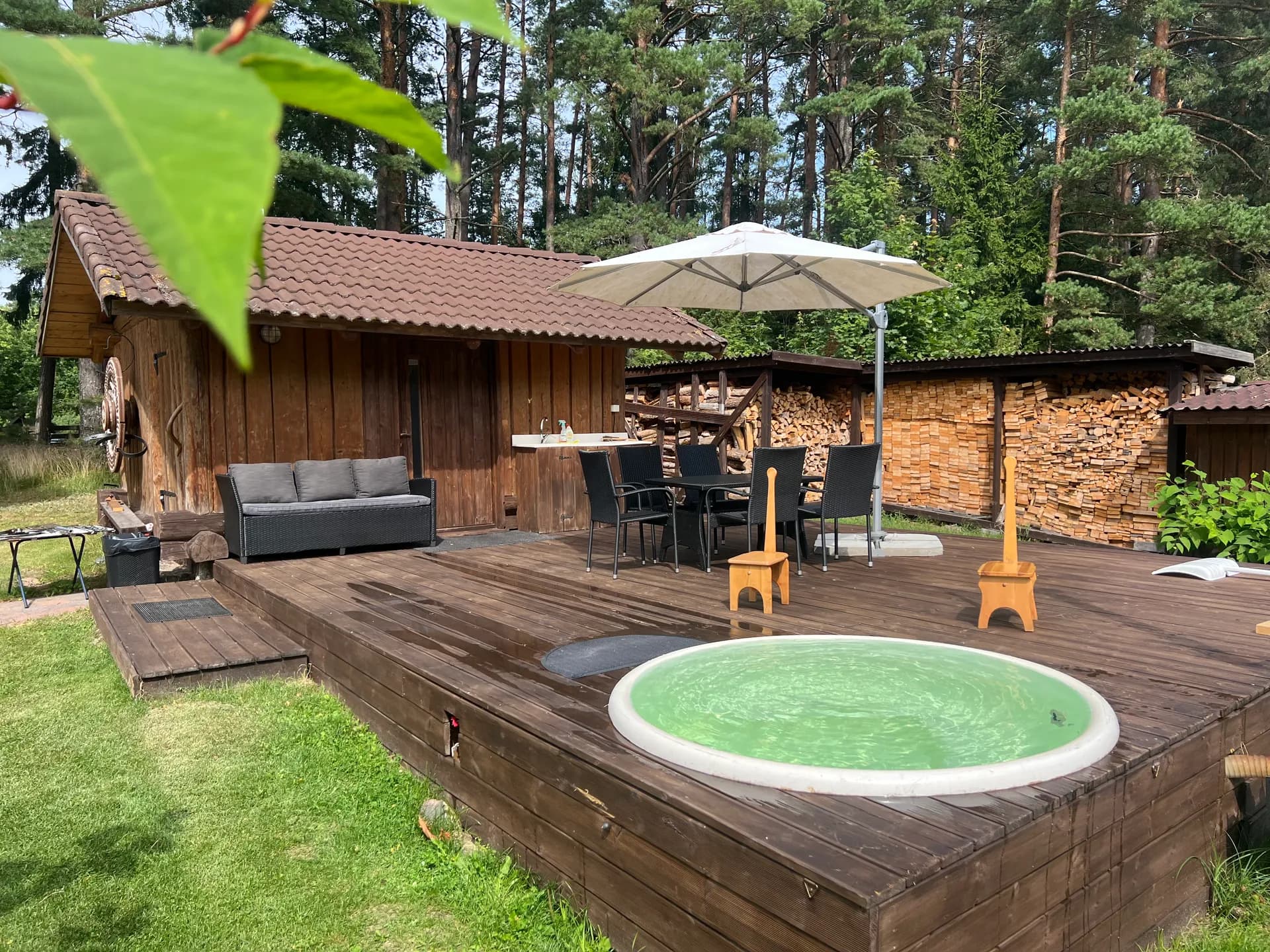 Standalone sauna building with terrace and hot tub